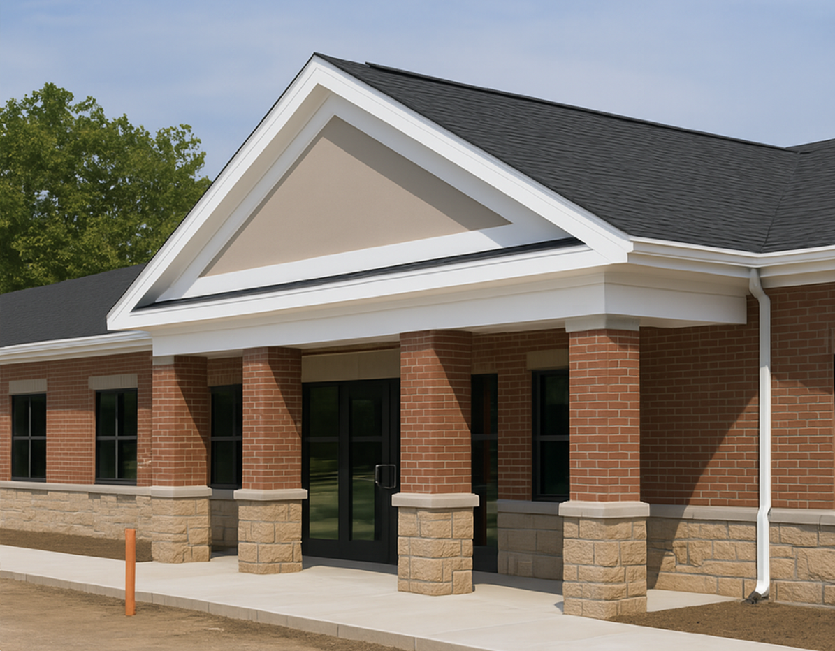 Institutional brick and stone building with columns and pitched roof, illustrating load-bearing masonry systems and code-compliant construction for schools, hospitals, or government facilities.