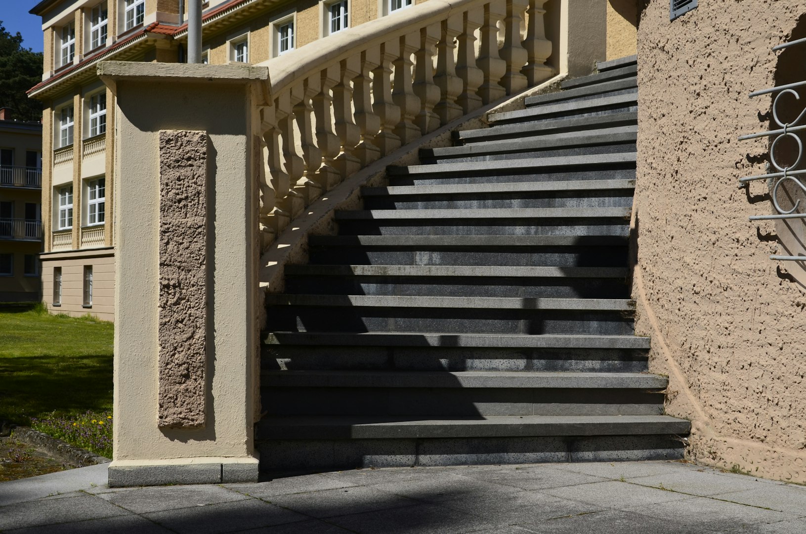 tone masonry staircase with a decorative curved balustrade in front of a residential building, representing brick and stone veneer, chimneys, fireplaces, and patios.
